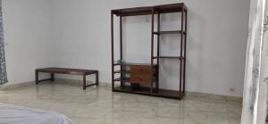 a room with a shelf and a table and a bench at Hôtel Belvédère in Toliara