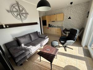 a living room with a couch and a table at Kompassrose in Prerow