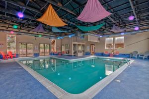 a large swimming pool with colorful flags hanging from the ceiling at Cavalier Condos #32 in Lincoln City