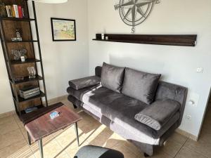 a living room with a couch and a table at Kompassrose in Prerow