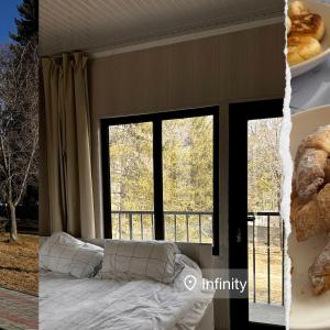 a bedroom with a bed and a window and a plate of food at Infinity Hotel in Cholpon-Ata +23 photos