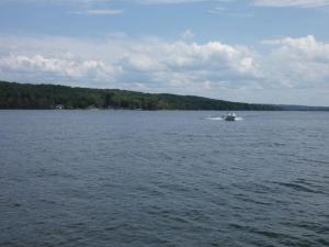 a boat in the middle of a large lake at Sandy Bottom Cottage on Intermediate Lake in Bellaire +29 photos