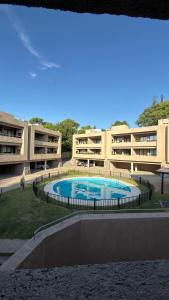 an external view of a building with a swimming pool at KIRA HAUS, North Green in Villa Allende