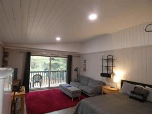 a living room with a bed and a couch at Happy Hour at Windcliff! Studio condo at Shanty Creek Resort in Bellaire