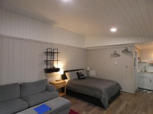 a bedroom with a bed and a couch at Happy Hour at Windcliff! Studio condo at Shanty Creek Resort in Bellaire