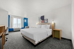 a hotel room with a large white bed and a window at Spark by Hilton Pelham Birmingham I 65 in Pelham +20 photos
