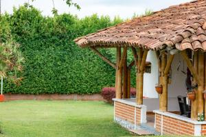 a pavilion with a roof on a lawn at El cantor Finca hotel in Quimbaya +19 photos