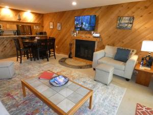 a living room with a couch and a table at Courtside Condo at Summit in Bellaire