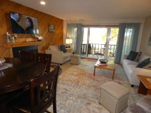 a living room with a table and a couch at Courtside Condo at Summit in Bellaire