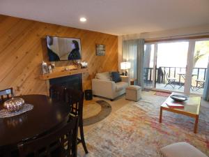 a living room with a table and a couch and a television at Courtside Condo at Summit in Bellaire +23 photos
