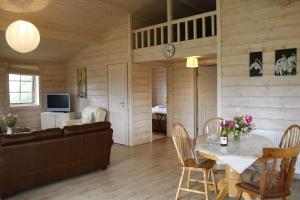 a living room with a couch and a table at Skylark Lodge in Dumfries