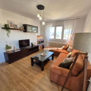 a living room with a couch and a table at Above the City, walk everywhere - 2BR, 2 Baths in Skopje