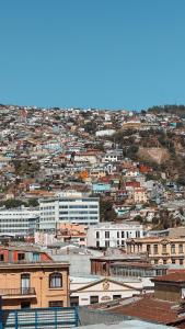a view of a city with buildings on a hill at Getaway in Valparaiso in Valparaíso +4 photos