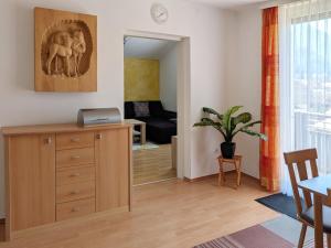 a living room with a wooden dresser and a dining room at Ferienwohnung Piontek in Ebensee