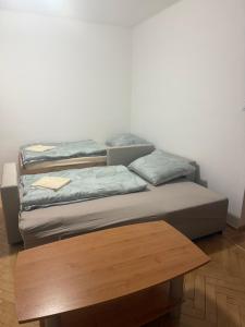 two beds sitting on top of a wooden table at Harmony apartment in Šamorín