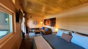 a bedroom with a bed and a living room at Bison Farm - Cabin "Vista" in Culpeper