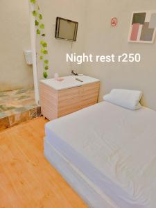 a bedroom with a bed and a dresser with a mirror at 26 molen street in Rustenburg +6 photos