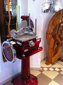 a musical instrument on a red stand in a room at Hotel Berna in Eraclea Mare