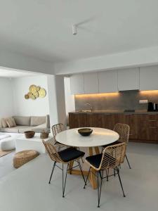 a kitchen and dining room with a table and chairs at Aura Sun Villa in Agios Romanos
