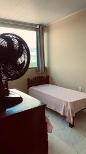 a room with two beds and a window at Quarto Triplo in Areia +5 photos
