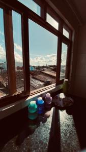 a room with three windows with a view of a field at Quarto Triplo in Areia