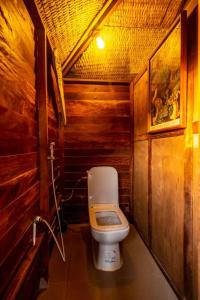 a bathroom with a toilet in a wooden room at Mansa Musso Lodge in Sanyang +59 photos
