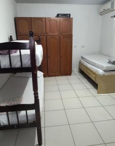 a room with a bed and a bunk bed at Espaço Pires in Jaciara