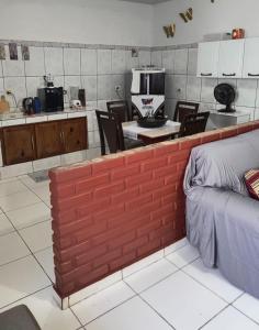 a kitchen and dining room with a brick wall at Espaço Pires in Jaciara