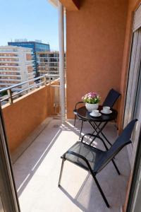 a patio with a table and chairs on a balcony at Premium Rent Podgorica in Podgorica
