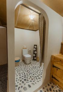 a bathroom with a toilet in a room at Dihya Luxury Camp in Merzouga