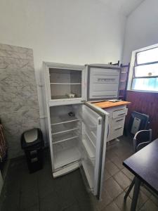 an empty refrigerator with its door open in a room at Buena Vista Centro in Concordia +6 photos