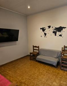 a room with a bed and a map on the wall at Buena Vista Centro in Concordia