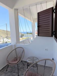 a room with two chairs and a table and a window at Kanal Vstay #2 in Kithnos