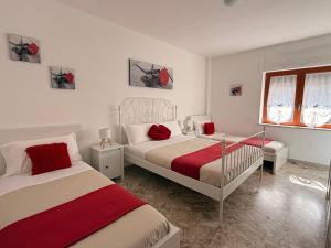 a bedroom with two beds and a window at Casa Sant'Antonio in Bari