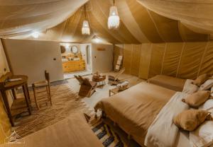 a bedroom with a bed in a tent at Dihya Luxury Camp in Merzouga