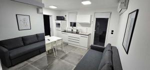 a living room with a couch and a kitchen at Kadenca in Umag