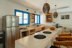 a kitchen with a refrigerator and a counter top at Casa Omero. in El Cuyo
