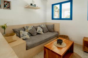 a living room with a couch and a table at Casa Omero. in El Cuyo +48 photos
