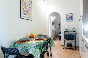 a dining room with a table and chairs and a kitchen at Titina Apartment Novoli Close to Center & Airport in Florence