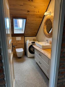 a bathroom with a sink and a washing machine at Haus Schönsee - 2 Apartments, ideal für Familien & Freunde in Heede +73 photos