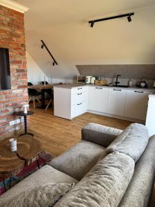 a living room with a couch and a kitchen at Haus Schönsee - 2 Apartments, ideal für Familien & Freunde in Heede