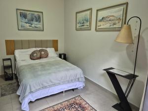a bedroom with a bed with two pillows on it at Chalé de Sampa in São Paulo