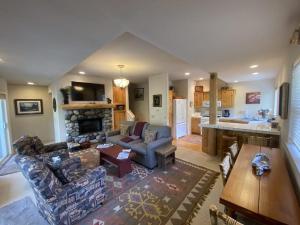 a living room with a couch and a fireplace at Sun Bird Getaway at River Run in Ketchum