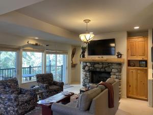 a living room with a couch and a fireplace at Sun Bird Getaway at River Run in Ketchum