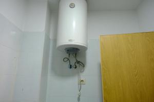 a light on a wall next to a door at Sea View Family Apartment Durres in Durrës