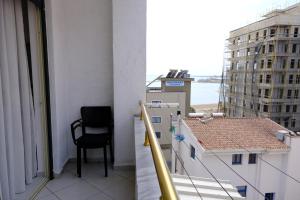 a chair on a balcony with a view of the ocean at Sea View Family Apartment Durres in Durrës +34 photos