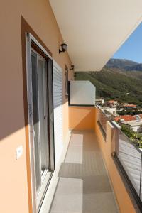 a balcony with a view of a city at Thea Rooms in Himare