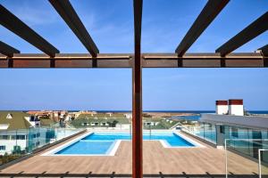 a view of the pool from the balcony of a building at Edificio Lux's - Apartamentos Tubarão in Santa Maria