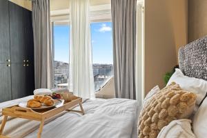 a hotel room with a tray of food on a bed at Chocolat in Odyssey Pool & Spa Resort in Mamaia Sat/Năvodari +46 photos