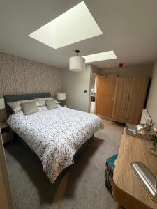 a bedroom with a bed with a white comforter at The Blue Bell Inn in Amble +3 photos